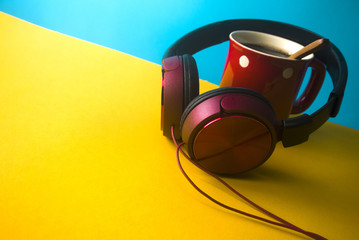 music headphone with hot coffee cup on yellow background