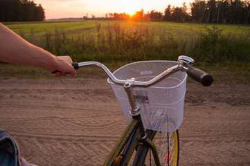 Obraz na płótnie Canvas Stylish guy on a bike at sunset, leisure