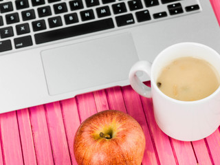 Cup of Mushroom Soup with a Red Apple and a Laptop Computer
