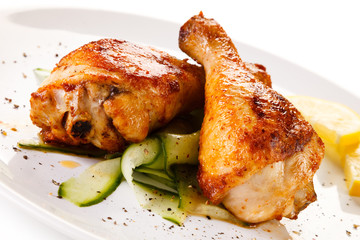 Roast chicken drumsticks on white background 