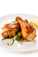 Roast chicken drumsticks on white background 