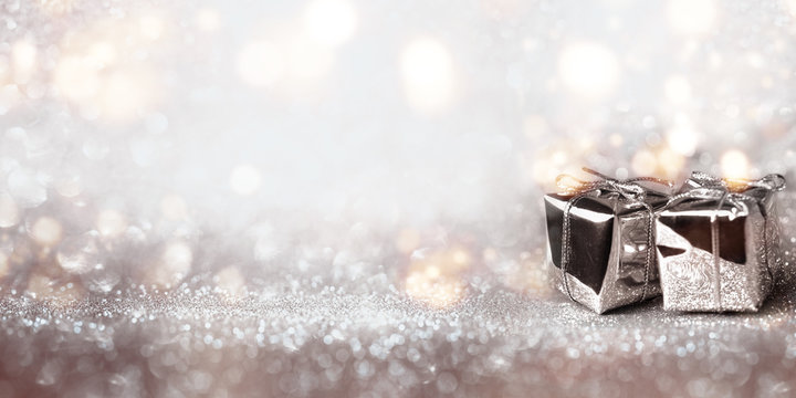 Shiny gifts on a silver bokeh background