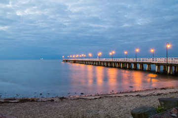 Fototapeta na wymiar Sunrise with pier at Baltic sea in Gdynia Orlowo.