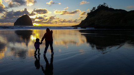 Sharing joy of the Cape with child at sunset on the coast