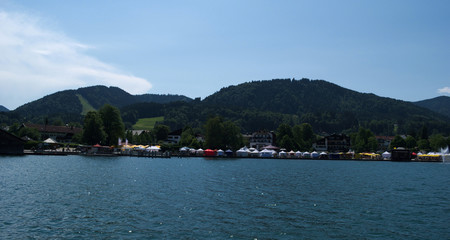 Fototapeta na wymiar Boating on the Tegernsee with a view over a Market at Bad Wiessee
