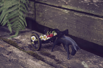 Horse pulling a cart with flowers and berries