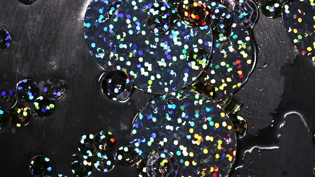 Abstract video clip. Multicolor sequins movie down, glowing paillette close-up. Background for tv show intro, opener, party, clubs, event, music clips, advertising footage. Slow motion
