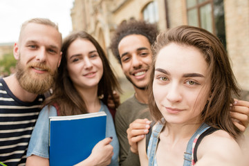 Multiethnic students smiling for selfie photo. Young people taking selfie photo in university campus.