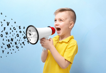Cute little boy with megaphone on color background