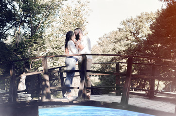 couple date on wooden bridge in the park