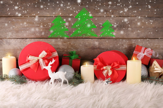 Christmas composition with gift boxes and decorations on wooden background