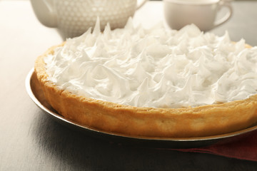 Delicious coconut cream pie on grey table