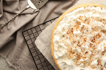 Grid with delicious coconut cream pie on grey table - obrazy, fototapety, plakaty