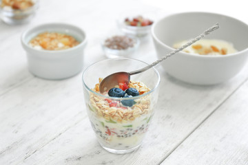 Tasty dessert with yogurt in glass on table