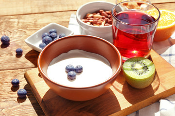 Tasty breakfast with yogurt on table