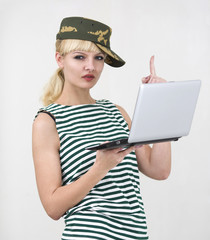 Woman in military uniform working on laptop