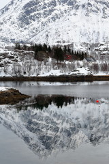 Red-white cottages on Sildpollnes peninsula-Lilandstinden mountain background. Austnesfjorden-Austvagoya-Lofoten-Norway. 0129
