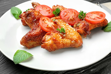 Plate with delicious chicken wings, closeup