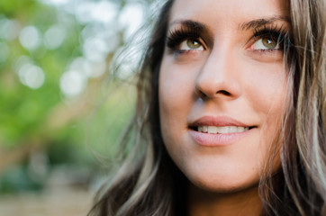 face of woman with green eyes and white teeth