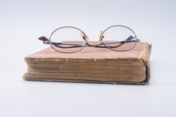 Bifocal glasses on brown vintage book