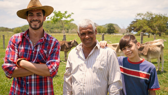 Three Generations Family Portrait Of Farmers In Farm