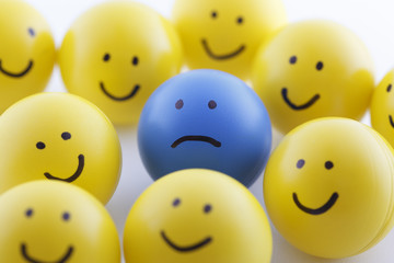 Close up of unhappy and happy smileys