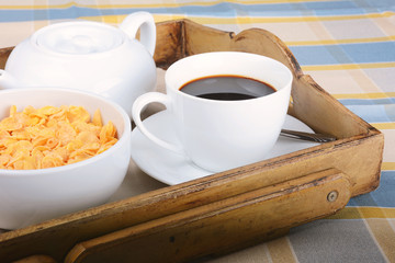 Breakfast tray with coffee and cereals.