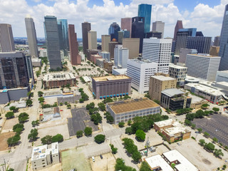 Aerial view Houston downtown against cloud blue sky with empty parking lot at weekends and background of skyscrapers/high-rises in the business district area. Architecture and travel background