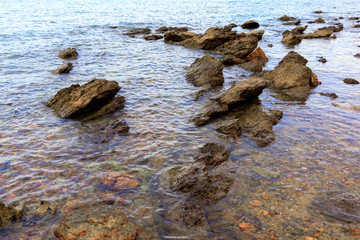 Stone in sea beach with wave