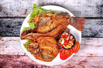 Deep fried Tilapia with spicy and sour herb salad .