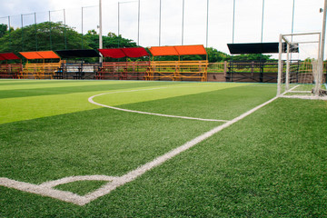 Photo of a green synthetic grass sports field with white line shot from above