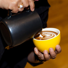 Cup of coffe latte art in coffee shop