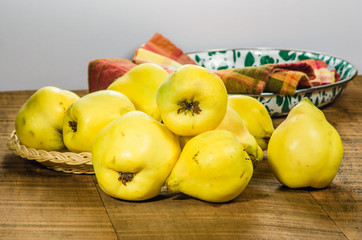 Yellow quince fruit in a wicker tray