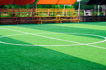 Obraz premium Photo of a green synthetic grass sports field with white line shot from above