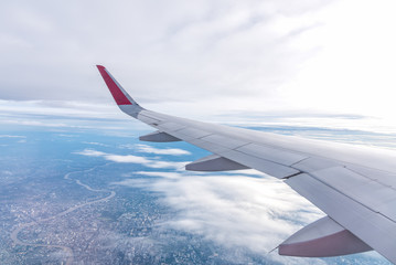 Obraz premium View of airplane wing.Flying high above the blue sky.