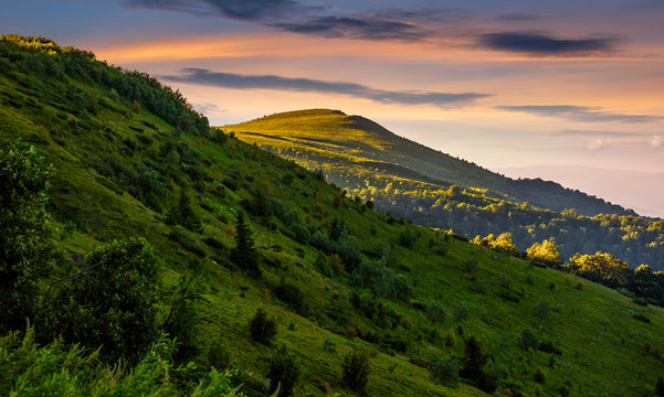 mountain ridge with peak behind the hillside at sunset