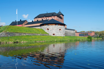 The fortress of the city of Hameenlina on the bank of the Vanayavesi lake in the sunny June afternoon. Finland