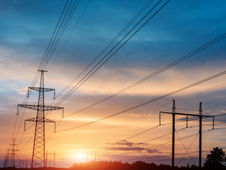 Fototapeta premium High power electricity poles in urban area. Energy supply, distribution of energy, transmitting energy, energy transmission, high voltage supply concept photo