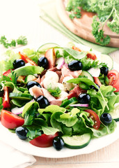 Salad with prosciutto crudo and black olives