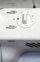 White thermostat dial inside refrigerator