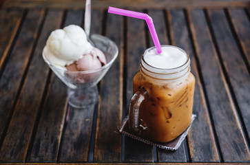 Summer Dessert, Iced Coffee with Ice Creams on wooden table, selective focus on Coffee Cup