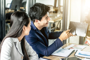 Close-up of business team using pen with financial diagram and digital tablet
