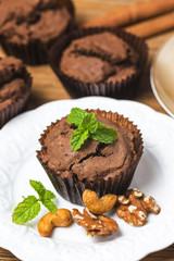 Chocolate cupcakes with mint on wooden table