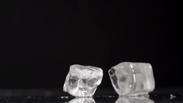Falling ice cubes on a black background