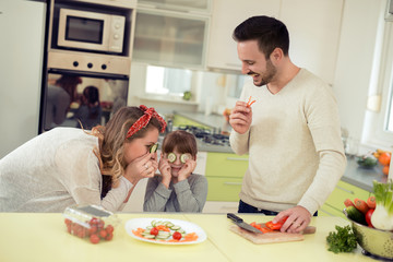 Happy smiling family in the kitchen preparing breakfast