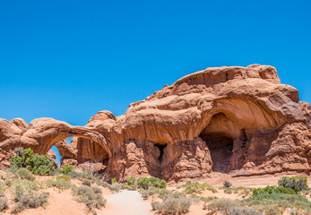Double arch. Natural picturesque stone arches in the Moab Desert