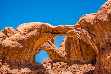 Double arch. Natural picturesque stone arch of sandstone in the desert Moab, Utah