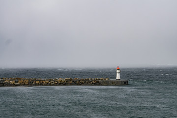 Lighthouse bracing against the storm - 165255634