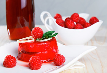 Delicious glazed cake with raspberries and juice.