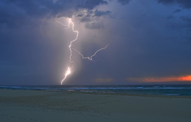 Weird shaped lightning strike over the Atlantic Ocean at sunset (Biscarrosse, France)